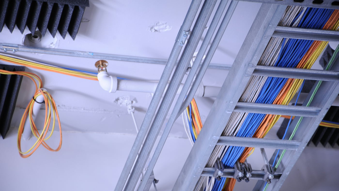 Cable tray carrying fibre and structured cabling through a facility